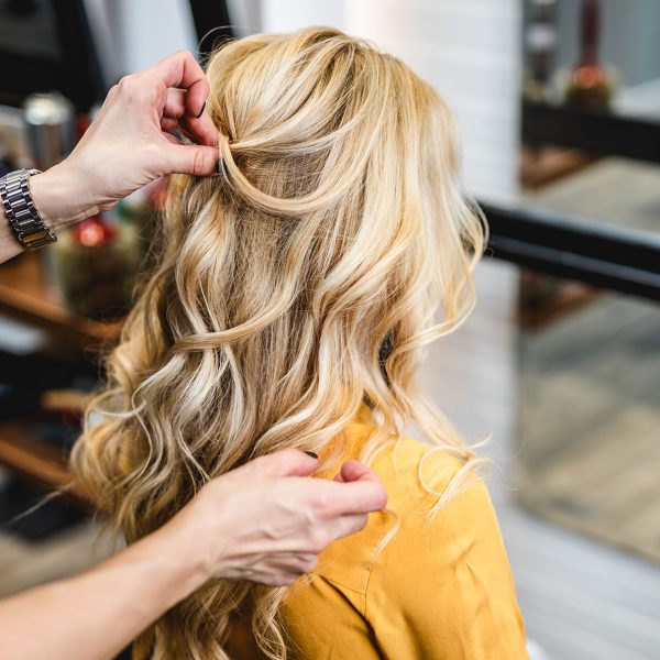 Beautiful blond middle-aged woman in modern hair salon.